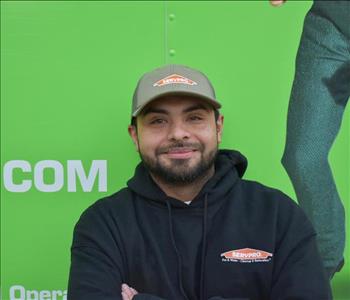 SERVPRO employee in front of green truck