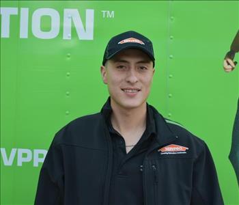 SERVPRO employee in front of green truck