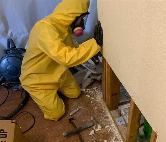 team member removing drywall