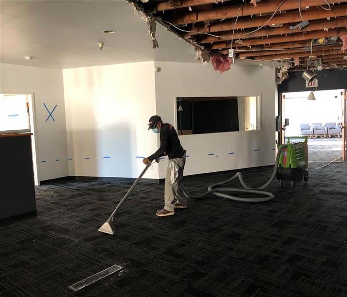 A specialist is removing water damage in a office