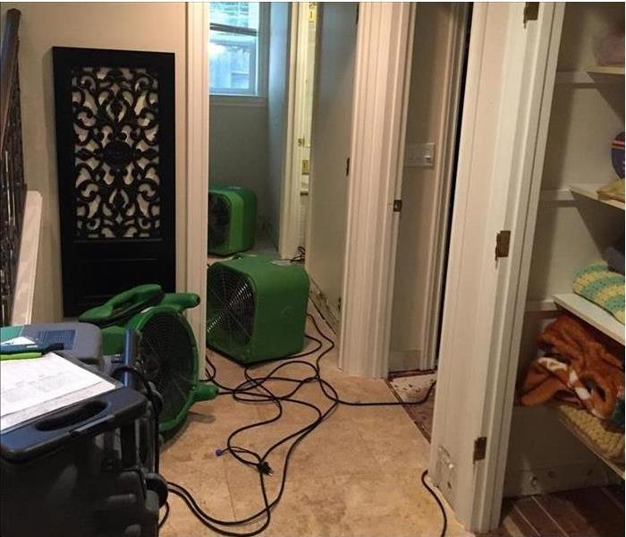 Restoration machines are drying out a house with water damage
